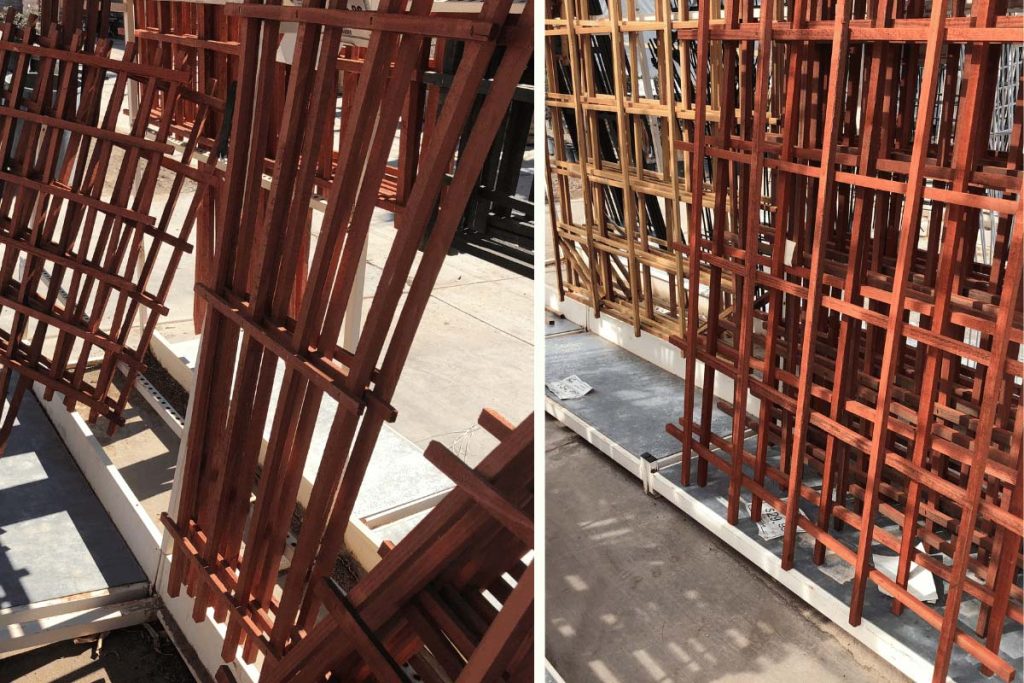 Wooden store-bought trellises stacked outdoors, ideal for supporting vertical crops in a square foot garden.